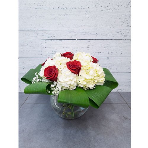 Arrangement of white hydrangea and red roses
