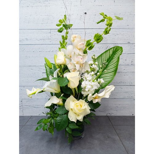 Arrangement of orchids, roses and white calla lilies