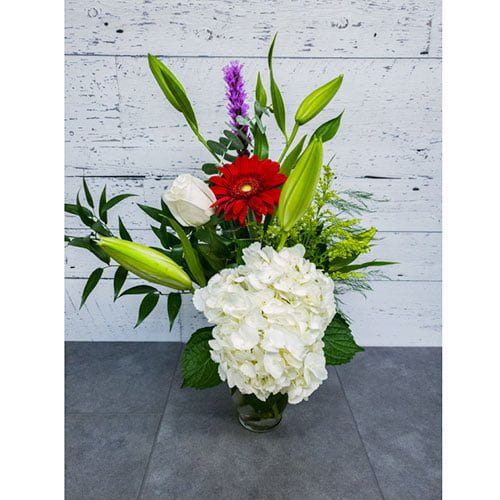Arrangement of hydrangea, roses, and gerberas