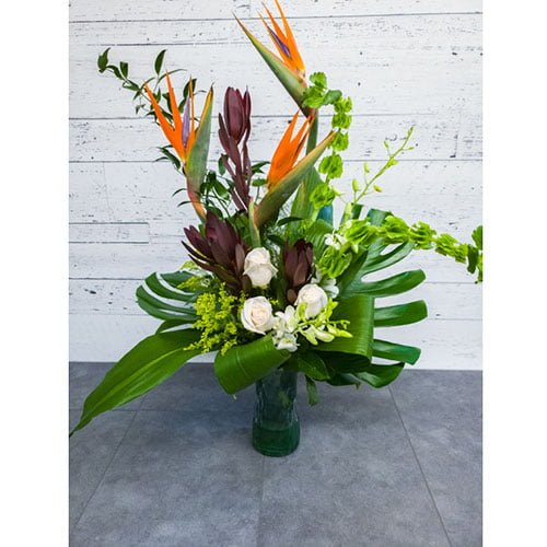 Arrangement of exotic flowers, roses and greenery