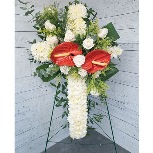 Cross composed of white, pink and anthurium flowers